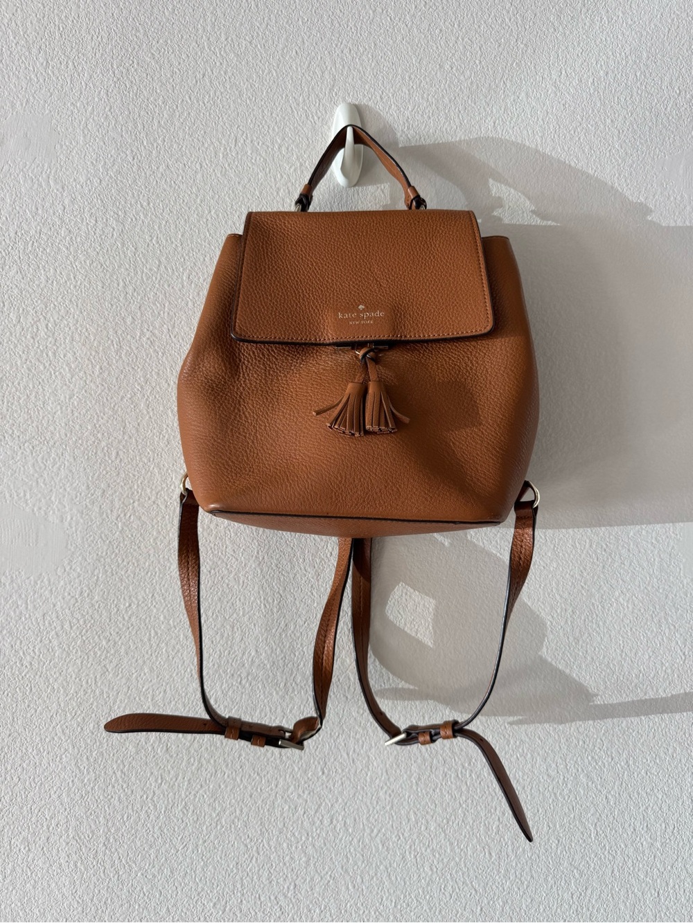 kate spade Pebbled Leather Tassel Backpack in Cognac